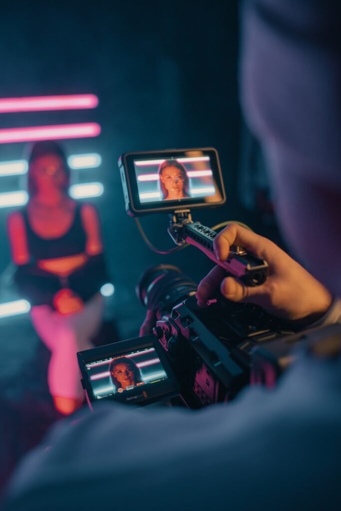 Video marketing, person holding black smartphone taking photo of man in black shirt