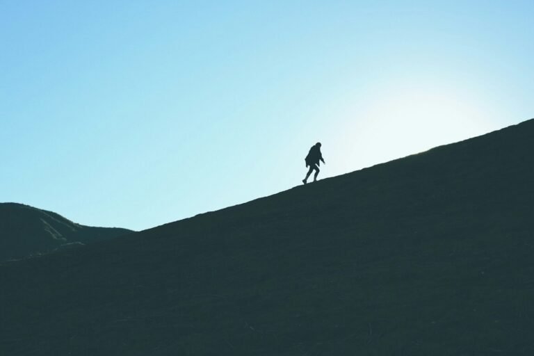 método Kaizen, silhouette of man climbing hill